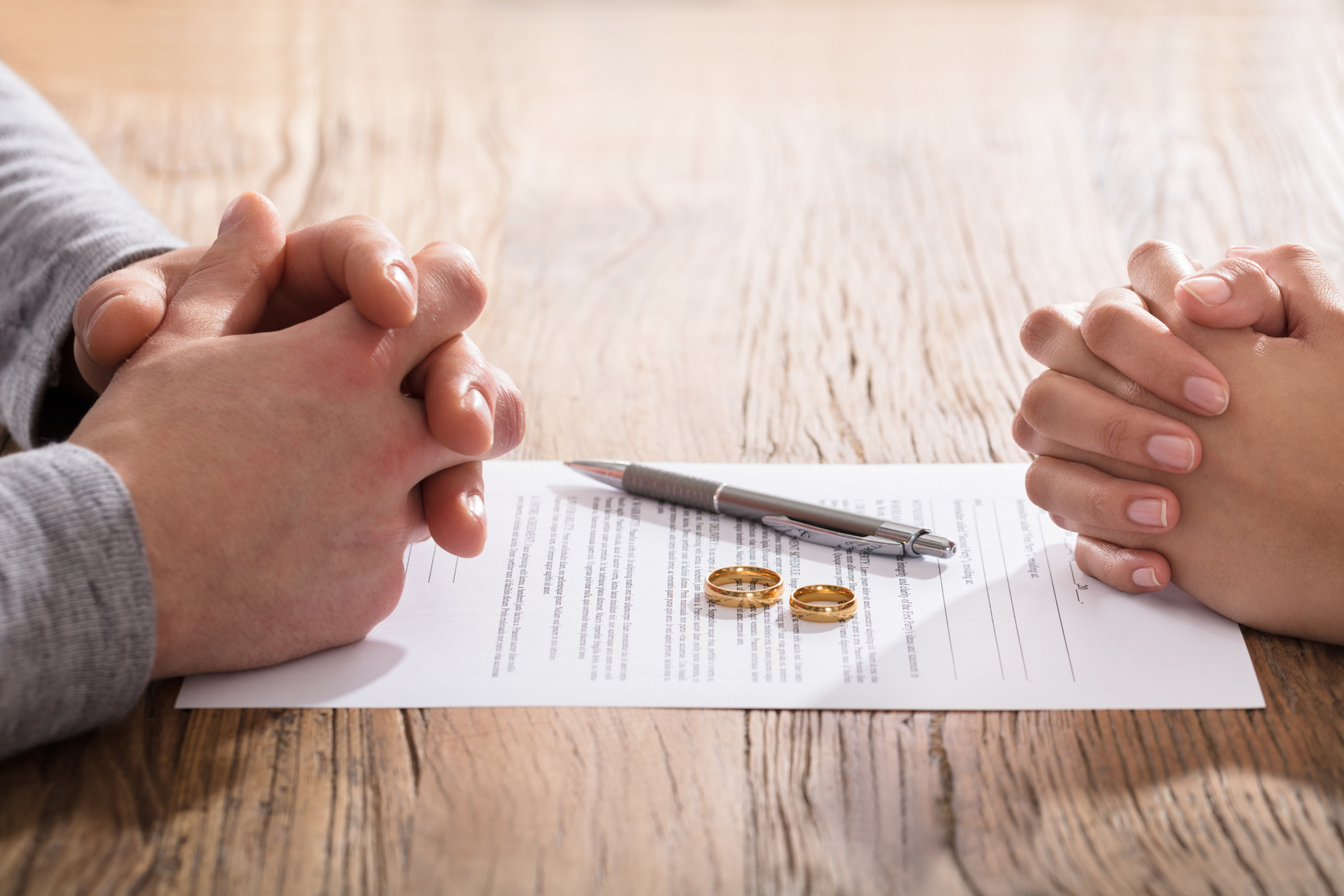 Couple's Hand On Divorce Agreement